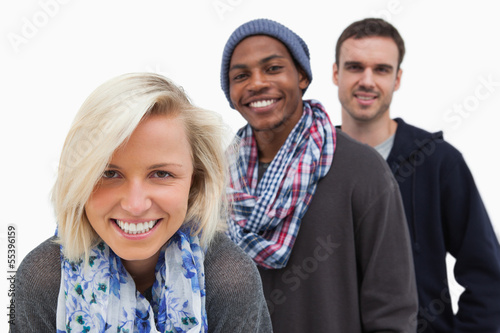 Photo: Three stylish friends looking at camera and smiling Three stylish friends looking at camera and smiling