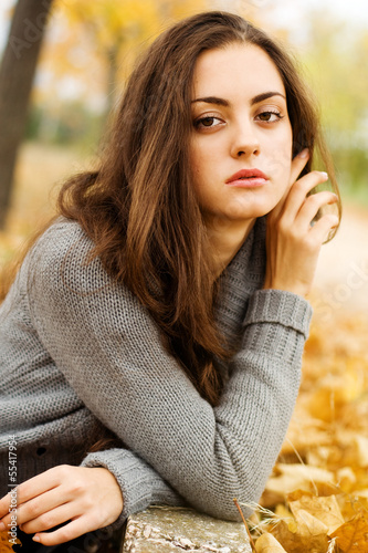 Photo: Autumn beautiful woman on leafs background Autumn beautiful woman on leafs background