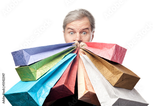 Photo: surprised mature man holding shopping bags near face isolated on surprised mature man holding shopping bags near face isolated on