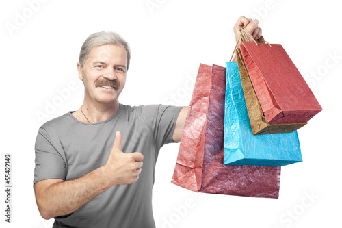 Photo: smiling mature man holding shopping bags isolated on white backg smiling mature man holding shopping bags isolated on white backg