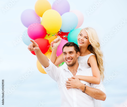 Photo: couple with colorful balloons at sea side couple with colorful balloons at sea side