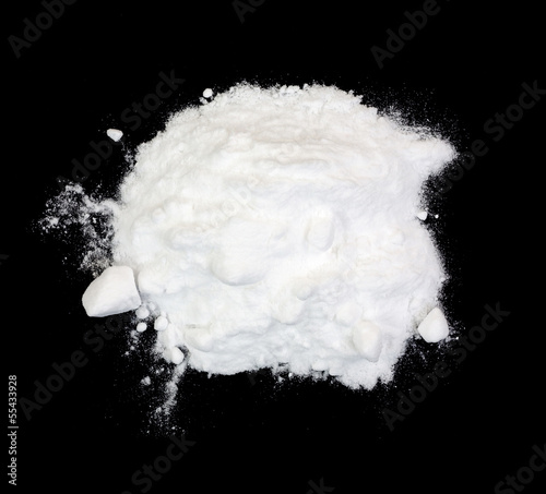 Photo: Baking soda on a black background Baking soda on a black background