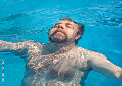 Photo: Middle-aged man in a swimming pool Middle-aged man in a swimming pool