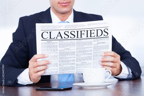 Photo: Businessman Reading Newspaper Businessman Reading Newspaper