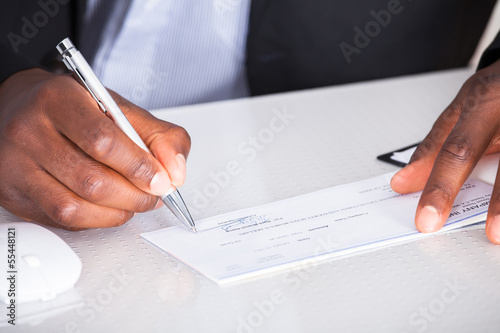 Photo: Human Hand Writing On Cheque Human Hand Writing On Cheque