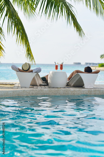 Photo: happy young couple relax and take fresh drink happy young couple relax and take fresh drink