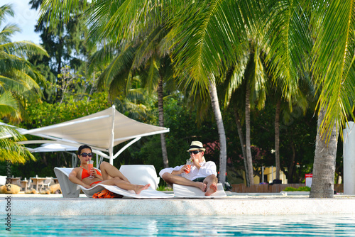 Photo: happy young couple relax and take fresh drink happy young couple relax and take fresh drink