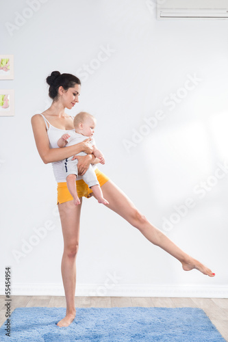 Photo: mother does gymnastics with her baby mother does gymnastics with her baby