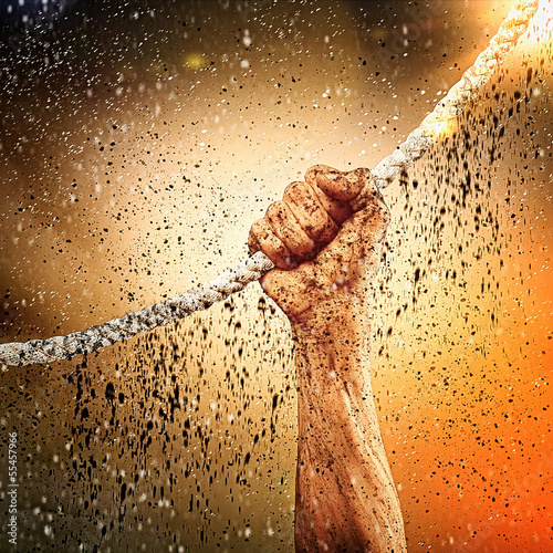 Photo: Human hand holding rope Human hand holding rope