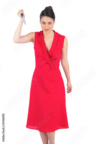 Photo: Frightening elegant brunette in red dress holding knife Frightening elegant brunette in red dress holding knife