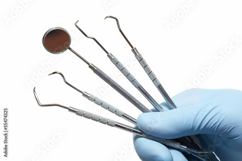 Photo: Hand with professional dental tools. Hand with professional dental tools.