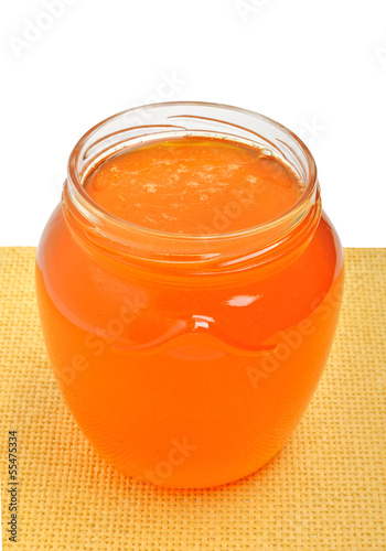 Photo: Glass jar with golden fresh honey Glass jar with golden fresh honey