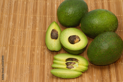 Photo: fresh avocado fruits on wooden background fresh avocado fruits on wooden background