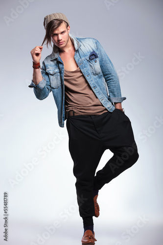 Photo: casual man on one leg pulls his hair casual man on one leg pulls his hair