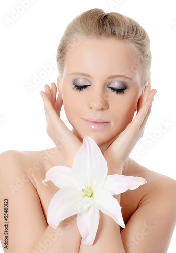 Photo: The beautiful blonde woman with lily flower The beautiful blonde woman with lily flower