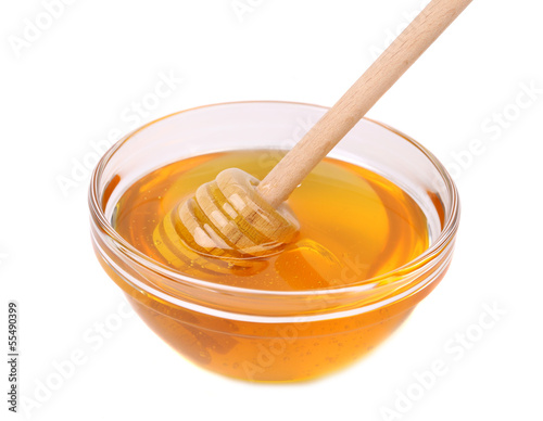 Photo: Glass bowl of honey with wooden drizzler Glass bowl of honey with wooden drizzler