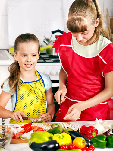 Photo: Children cooking at kitchen. Children cooking at kitchen.
