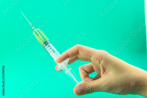 Photo: Syringe with a medicine in a female hand Syringe with a medicine in a female hand