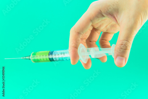 Photo: Syringe with a medicine in a female hand Syringe with a medicine in a female hand