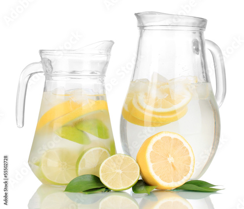 Photo: Cold water with lime, lemon and ice in pitchers isolated Cold water with lime, lemon and ice in pitchers isolated