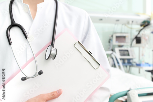 Photo: Doctor with clipboard and stethoscope in hospital Doctor with clipboard and stethoscope in hospital