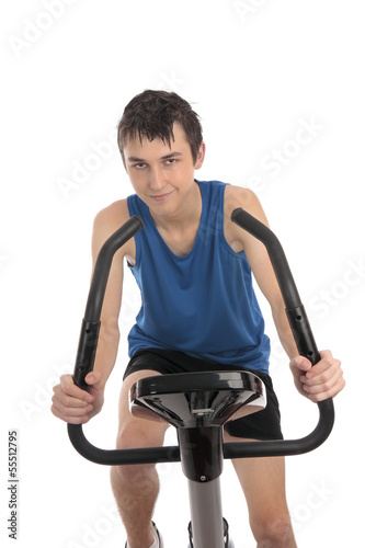 Photo: Teenage boy using an exercise bike fitness Teenage boy using an exercise bike fitness