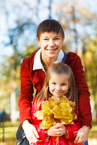 Photo: Mother with daughter in autumn park Mother with daughter in autumn park