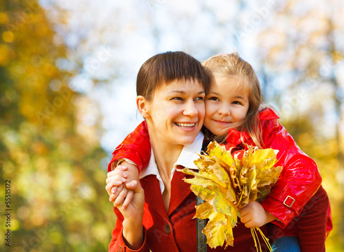 Photo: Mother with daughter in autumn park Mother with daughter in autumn park