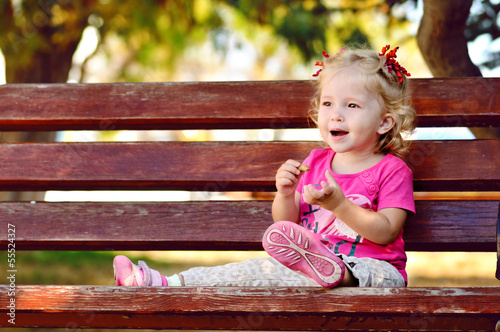 Photo: toddler girl on the bench toddler girl on the bench