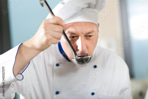 Photo: Chef working in his kitchen Chef working in his kitchen