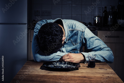 Photo: Sad man alone in his kitchen Sad man alone in his kitchen