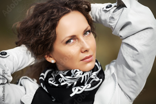 Photo: Happy beautiful woman in white coat Happy beautiful woman in white coat
