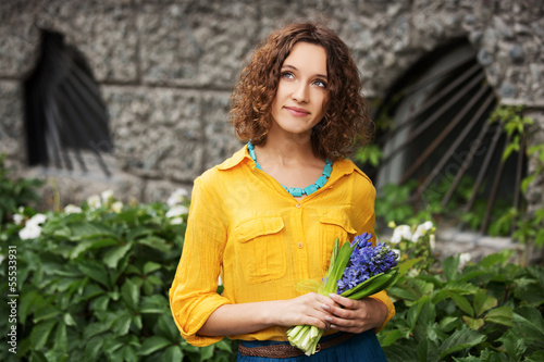 Photo: Happy young woman with bouquet of flowers Happy young woman with bouquet of flowers