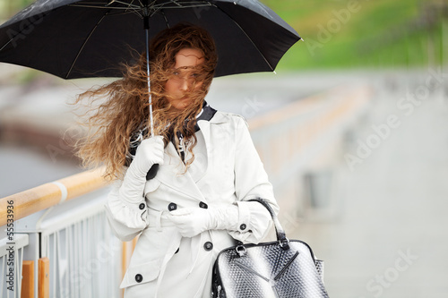 Photo: Beautiful woman with umbrella in the rain Beautiful woman with umbrella in the rain