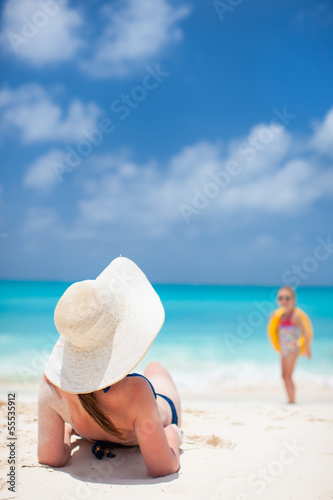 Photo: Young woman relaxing on beach Young woman relaxing on beach