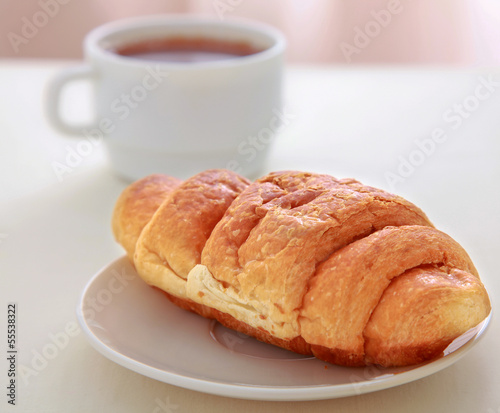 Photo: Croissants, coffee, on wooden table Croissants, coffee, on wooden table