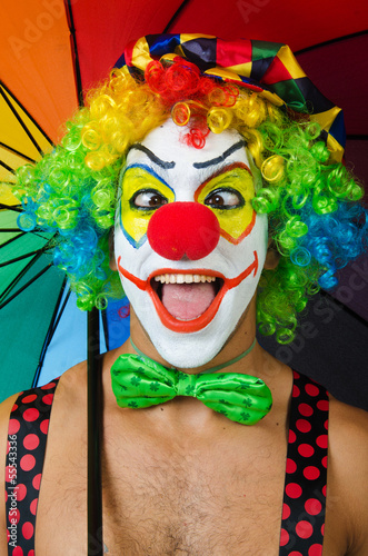 Photo: Clown with umbrella isolated on white Clown with umbrella isolated on white