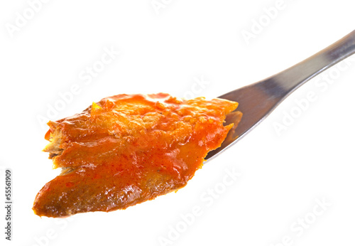 Photo: Herring in tomato sauce on fork Herring in tomato sauce on fork