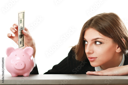 Photo: Young beautiful woman sitting with piggy bank (money box) Young beautiful woman sitting with piggy bank (money box)