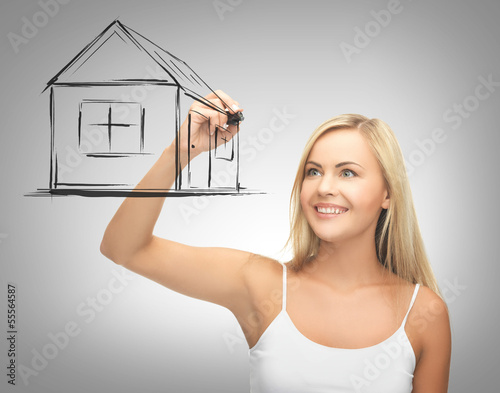 Photo: woman drawing house on virtual screen woman drawing house on virtual screen