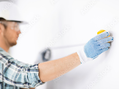 Photo: architect measuring wall with flexible ruler architect measuring wall with flexible ruler