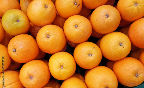 Photo: many fresh raw orange display at market many fresh raw orange display at market