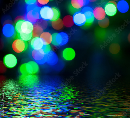 Photo: Colorful circular bokeh reflected in water surface. Colorful circular bokeh reflected in water surface.