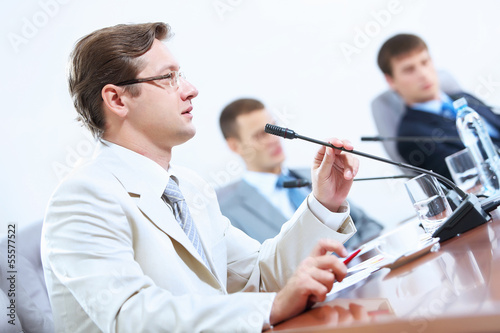 Photo: Three businesspeople at meeting Three businesspeople at meeting