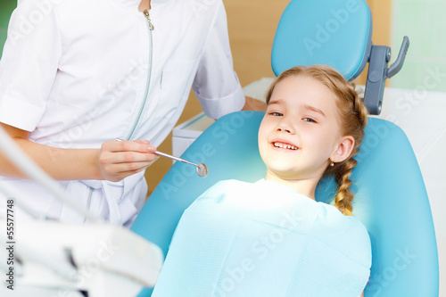 Photo: Little girl visiting dentist Little girl visiting dentist