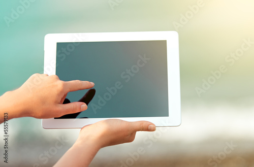 Photo: white tablet with a blank screen in the hands white tablet with a blank screen in the hands
