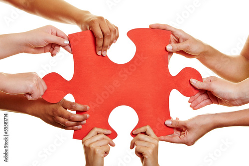 Photo: Hands holding red jigsaw puzzle Hands holding red jigsaw puzzle
