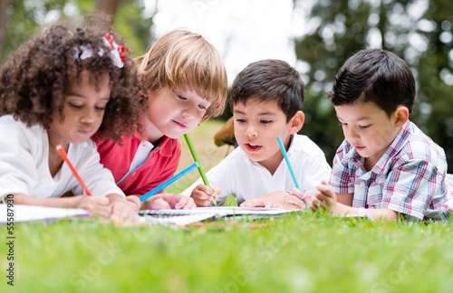 Photo: Happy school kids coloring Happy school kids coloring