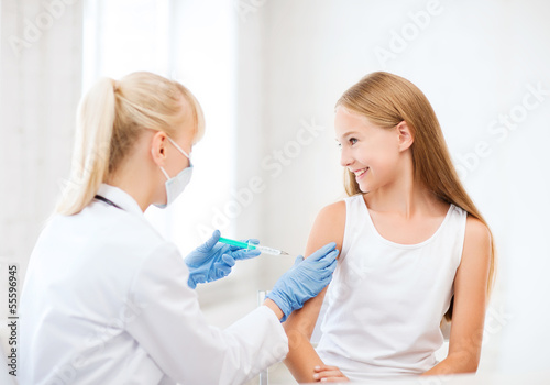Photo: doctor doing vaccine to child in hospital doctor doing vaccine to child in hospital
