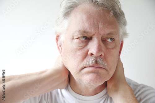 Photo: mature man with neck pain mature man with neck pain